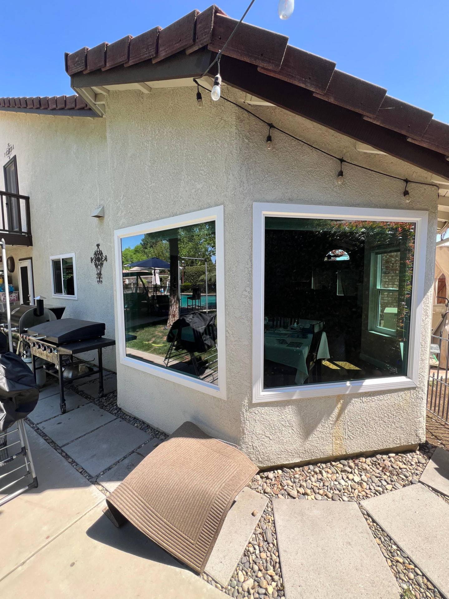 Two large patio windows cleaned spotless on a stucco home