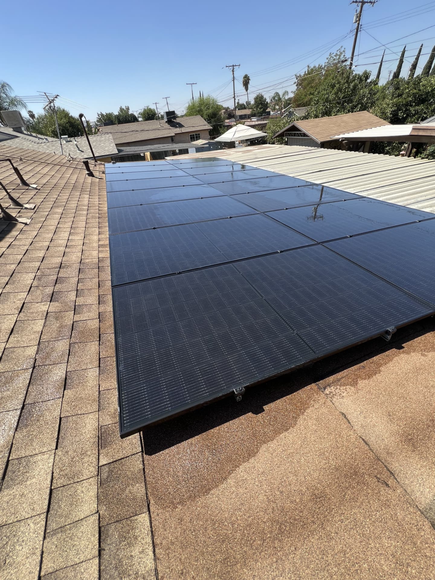 Low-slope solar array rinsed clean with pure water on a residential roof