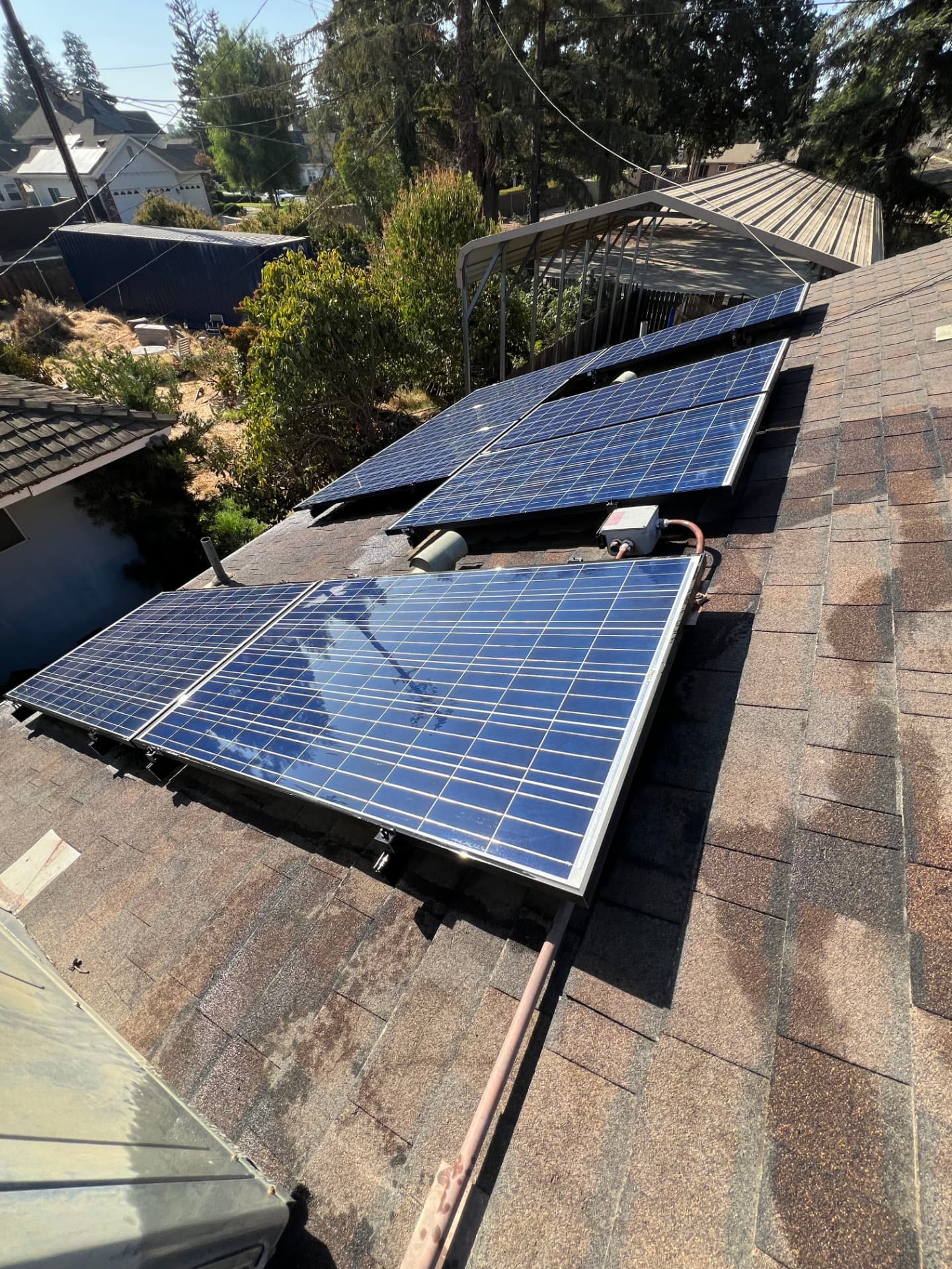 Spotless tilted solar panels on a residential roof after cleaning