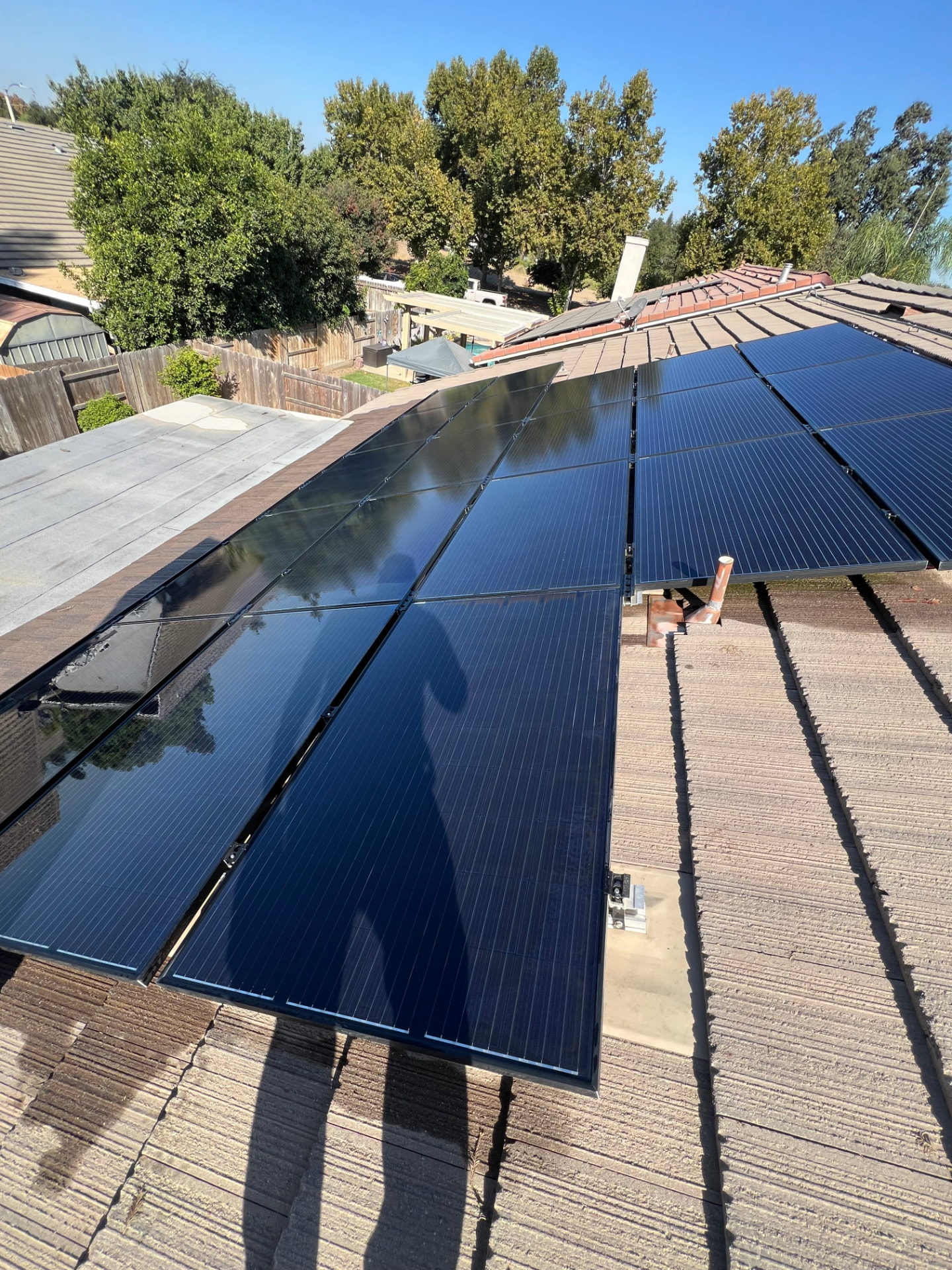 All-black solar panels washed clean on a tile roof