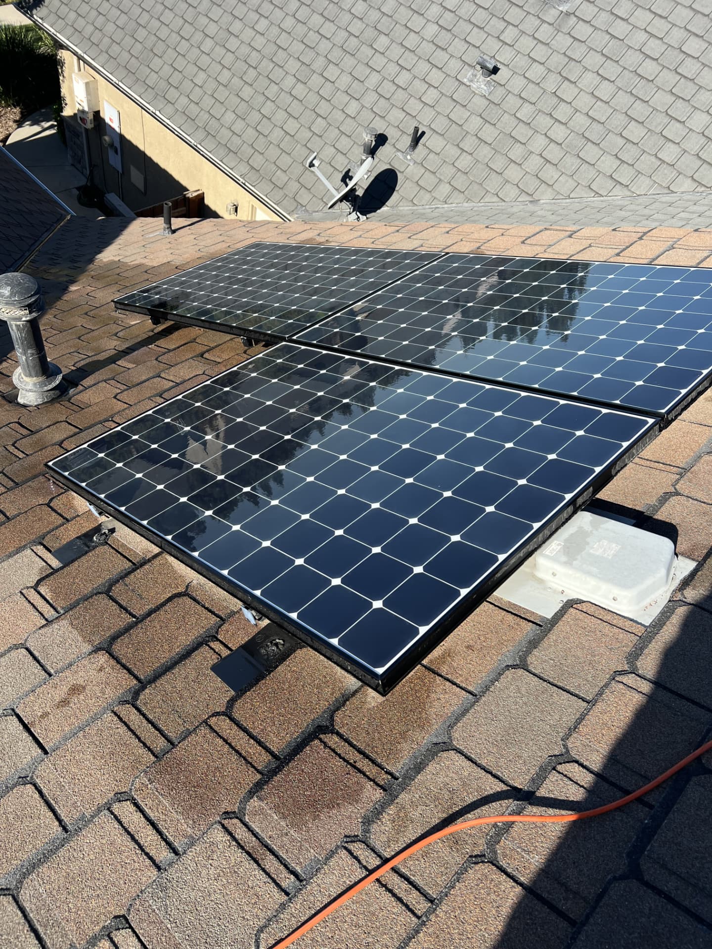 Small solar array polished spotless on a shingle roof