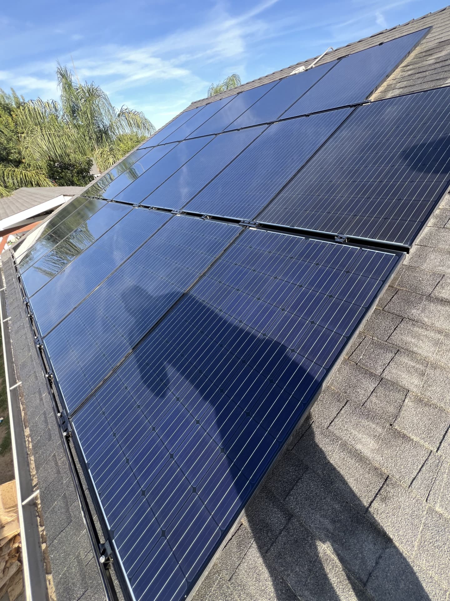Mirror-clean blue solar panels reflecting the sky after a deionized water wash